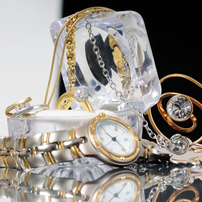 A small pile of fancy watches and jewelry. 