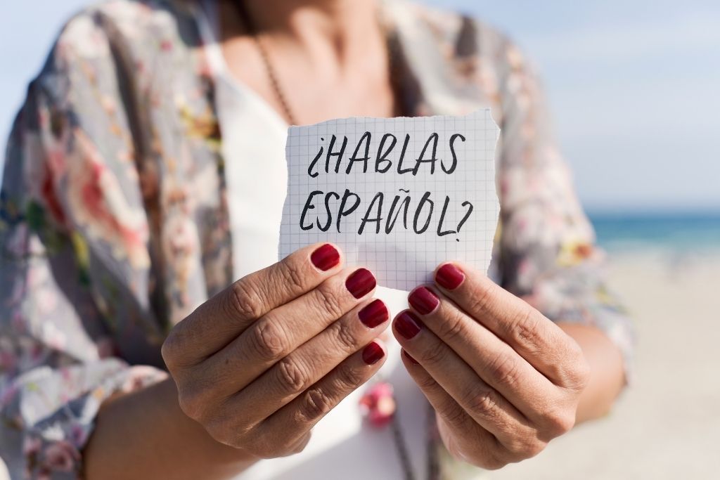 Women holding a signing that says ?Hablas Español? Translated to "do you speak Spanish?" It's worth it to learn a couple of key phrases in Spanish when visiting Tulum.  
