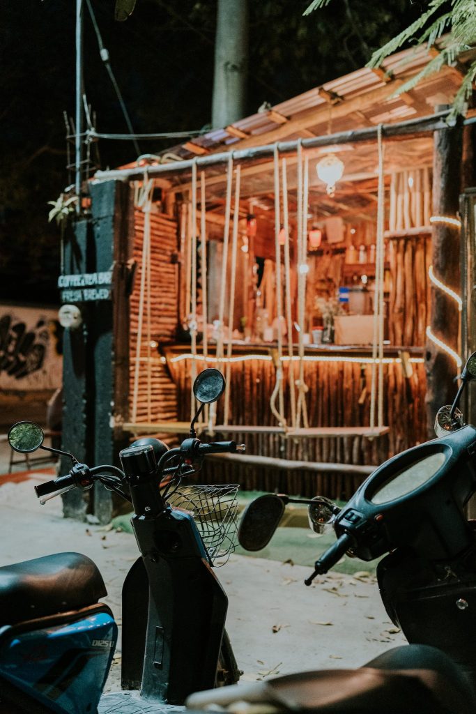 A scooter (moped) parked outside of a hotel zone beach bar in Tulum. Mopeds are the preferred method of navigating Tulum. 
